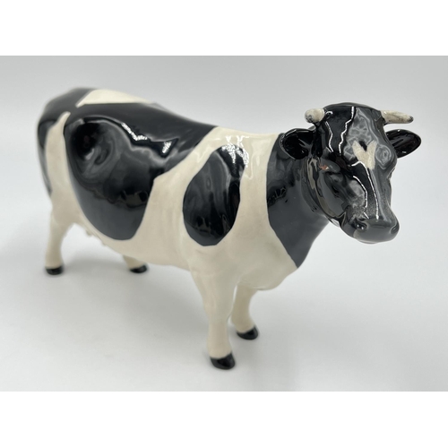 36 - Three Beswick Fresian Cattle figurines, Ch. Claybury Leegwater bull, Ch. Claybury Leegwater cow and ... 