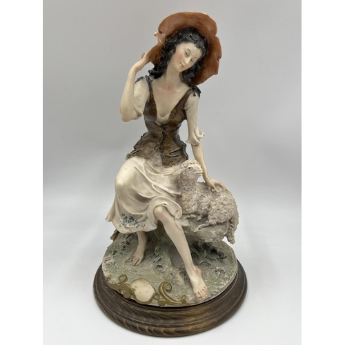 48 - Two Capodimonte figurines, one of a girl lying down signed Sandro Maggioni - approx. 12cm high x 23c... 