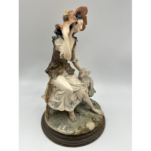 48 - Two Capodimonte figurines, one of a girl lying down signed Sandro Maggioni - approx. 12cm high x 23c... 