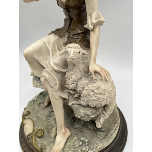 48 - Two Capodimonte figurines, one of a girl lying down signed Sandro Maggioni - approx. 12cm high x 23c... 