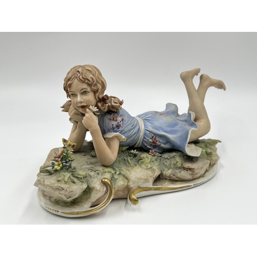 48 - Two Capodimonte figurines, one of a girl lying down signed Sandro Maggioni - approx. 12cm high x 23c... 