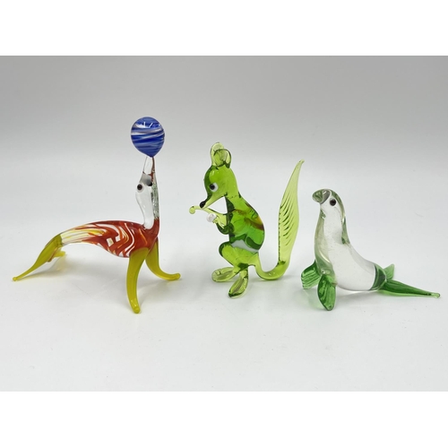 49 - Fourteen studio glass animal figurines to include penguin, frog, elephant etc.