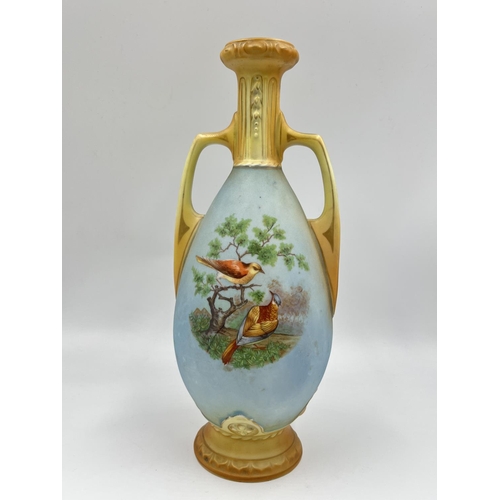 52 - A pair of late 19th/early 20th century Blush Ivory porcelain twin handled vases depicting bird scene... 