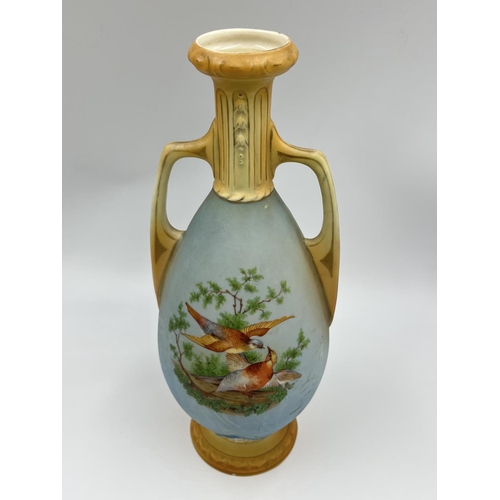 52 - A pair of late 19th/early 20th century Blush Ivory porcelain twin handled vases depicting bird scene... 