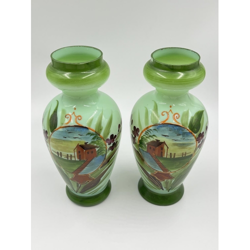 54 - A pair of late 19th/early 20th century hand painted glass vases - approx. 21cm high