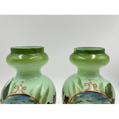 54 - A pair of late 19th/early 20th century hand painted glass vases - approx. 21cm high