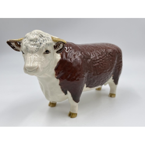 65 - A Beswick Ch. of Champions Hereford Bull figurine - approx. 11cm high x 19cm long