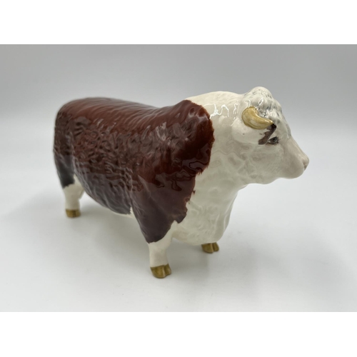 65 - A Beswick Ch. of Champions Hereford Bull figurine - approx. 11cm high x 19cm long