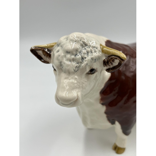 65 - A Beswick Ch. of Champions Hereford Bull figurine - approx. 11cm high x 19cm long