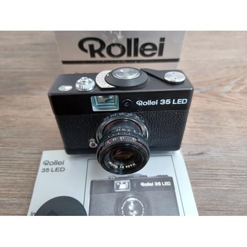 512 - A boxed and cased late 1970s Rollei 35 LED compact 35mm camera with instruction manual