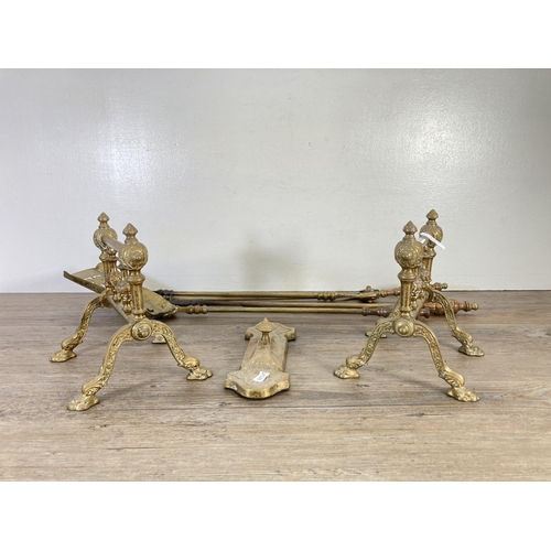 127 - Six pieces of brassware, two fire dogs, three piece companion set and one door handle - approx. 24cm... 