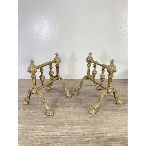 127 - Six pieces of brassware, two fire dogs, three piece companion set and one door handle - approx. 24cm... 