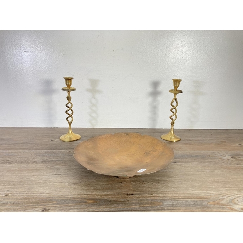 128 - Five pieces of brass and copper ware, two barley twist candlesticks, pierced trivet stand, circular ... 