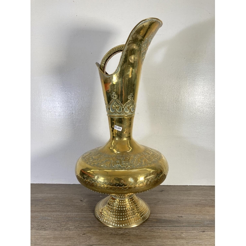 130 - Two pieces of Indian brassware, one 60cm ewer and one 56cm charger