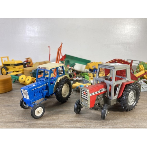 142 - A collection of Britains Limited model farm vehicles and figurines