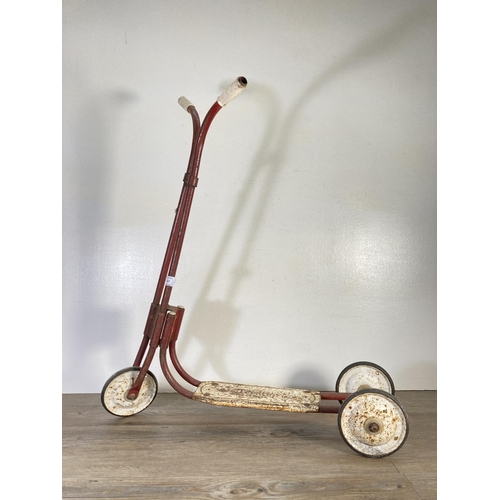 147 - A mid 20th century Tri-ang red metal scooter - approx. 74cm high x 68cm long