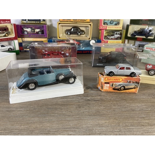 169 - A collection of assorted boxed diecast model vehicles to include Matchbox Models of Yesteryear 1912 ... 