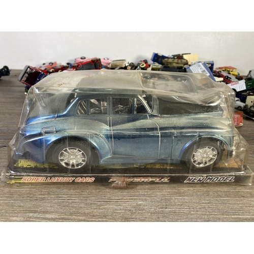 180 - A large collection of assorted diecast model vehicles to include Polistil Rolls Royce Corniche Droph... 