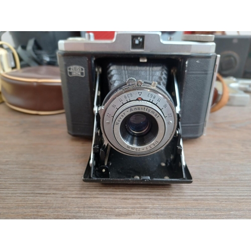 529 - Four items, one cased Zeiss Ikon Nettar II 517/16 horizontal folding camera for 120 film fitted with... 