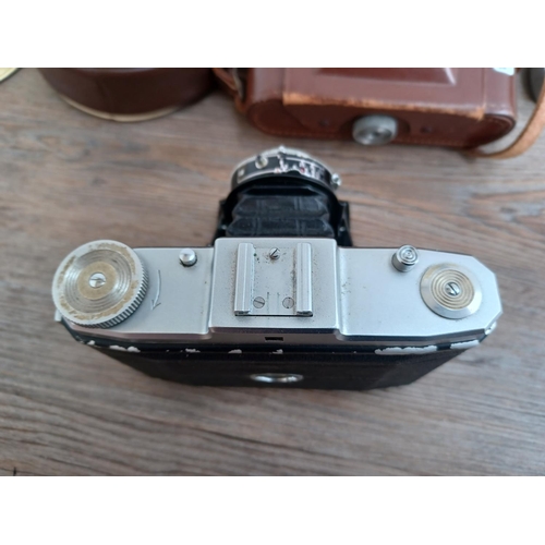 529 - Four items, one cased Zeiss Ikon Nettar II 517/16 horizontal folding camera for 120 film fitted with... 