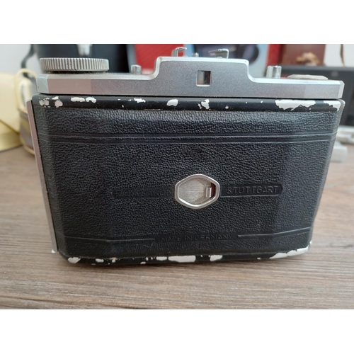 529 - Four items, one cased Zeiss Ikon Nettar II 517/16 horizontal folding camera for 120 film fitted with... 