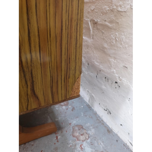 445 - A mid 20th century teak and rosewood effect sideboard with three cupboard doors and three drawers - ... 