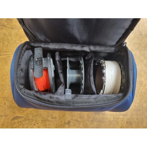 663 - A cased Leeda LC100 fly fishing reel with two spare spools