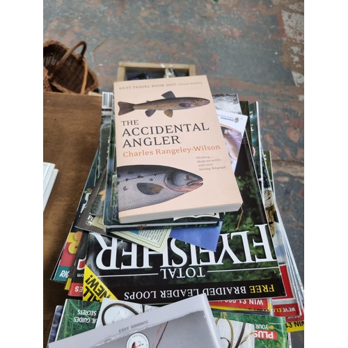 684 - A large collection of various fishing magazines and books to include mainly fly fishing