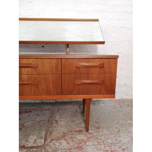 427 - An Austinsuite teak dressing table with six drawers and upper mirror - approx. 117cm high x 151cm wi... 