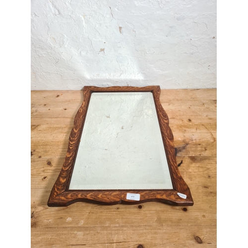 502 - A 1930s oak framed bevelled edge wall hanging mirror - approx. 67cm high x 42cm wide