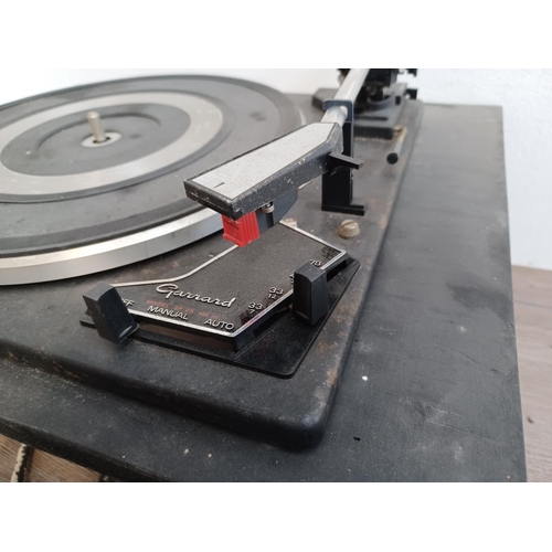 566 - A collection of vintage hi-fi to include Garrard SP25 Mk III three speed turntable, Garrard AT6 four... 