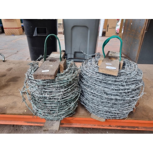 709 - Two large rolls of barbed wire fencing