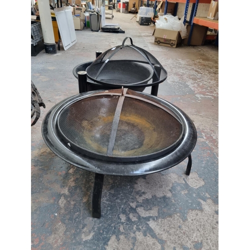 743 - Two metal firepits - largest approx. 50cm high x 55cm diameter