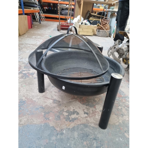 743 - Two metal firepits - largest approx. 50cm high x 55cm diameter