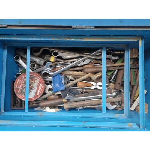 728 - A vintage metal tools chest on castors containing a large collection of various tools