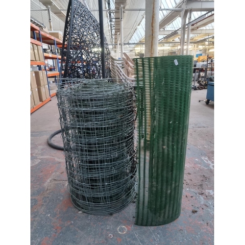 768 - Two rolls of garden fencing, one plastic and one steel