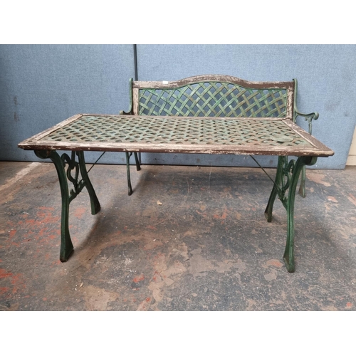 770 - Two pieces of cast iron and wooden garden furniture comprising table - approx. 58.5cm high x 116cm w... 