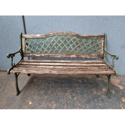 770 - Two pieces of cast iron and wooden garden furniture comprising table - approx. 58.5cm high x 116cm w... 