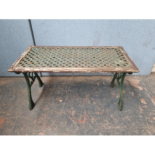 770 - Two pieces of cast iron and wooden garden furniture comprising table - approx. 58.5cm high x 116cm w... 