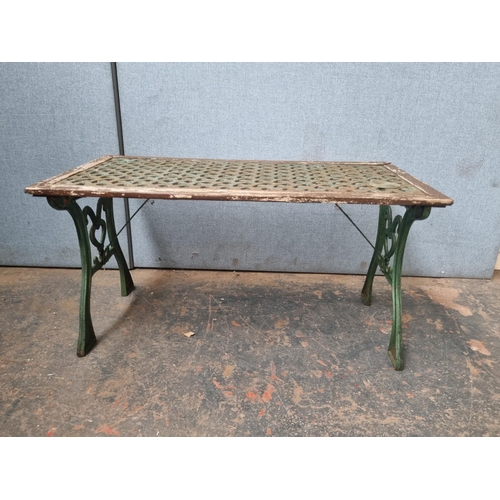 770 - Two pieces of cast iron and wooden garden furniture comprising table - approx. 58.5cm high x 116cm w... 