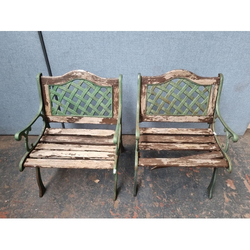 771 - A pair of cast iron and wooden slatted garden armchairs - approx. 80cm high x 58cm wide x 54cm deep