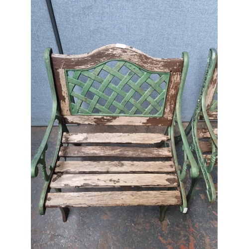 771 - A pair of cast iron and wooden slatted garden armchairs - approx. 80cm high x 58cm wide x 54cm deep