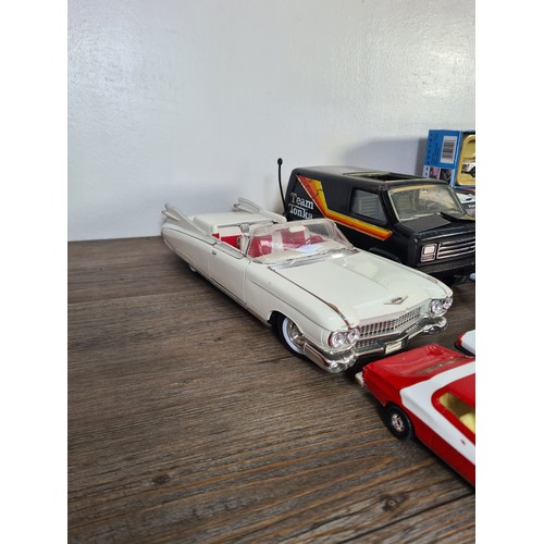 240A - A collection of assorted diecast model vehicles and toys to include Maisto 1959 Cadillac, Team Tonka... 