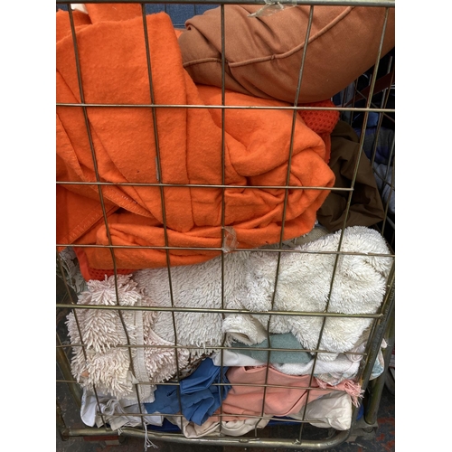 771B - Three cages containing a large quantity of clothing and materials (cages not included)