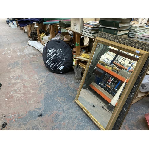 772 - A large collection of house clearance items to include two framed beveled edge wall mirrors, two ant... 