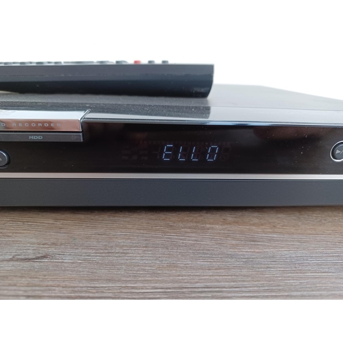 568 - An LG RHT399H HDD and DVD recorder with remote control