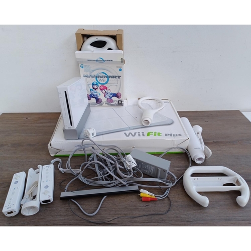 575 - A collection of Nintendo Wii items to include console, two Wii remotes, sensor bar, power adapter, b... 