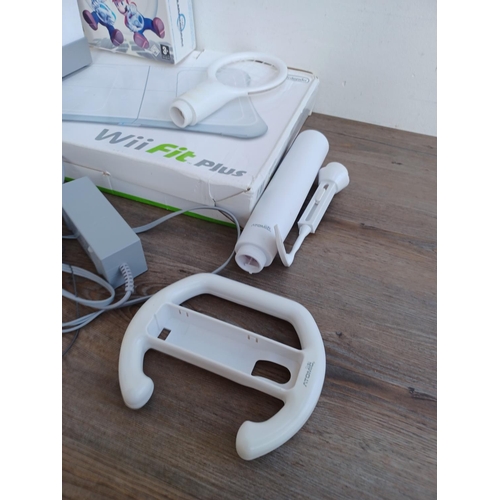 575 - A collection of Nintendo Wii items to include console, two Wii remotes, sensor bar, power adapter, b... 