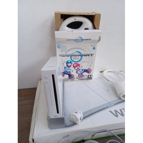 575 - A collection of Nintendo Wii items to include console, two Wii remotes, sensor bar, power adapter, b... 