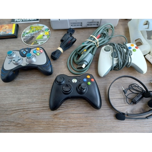 576 - A collection of games consoles, games and accessories to include Sony Playstation console with contr... 